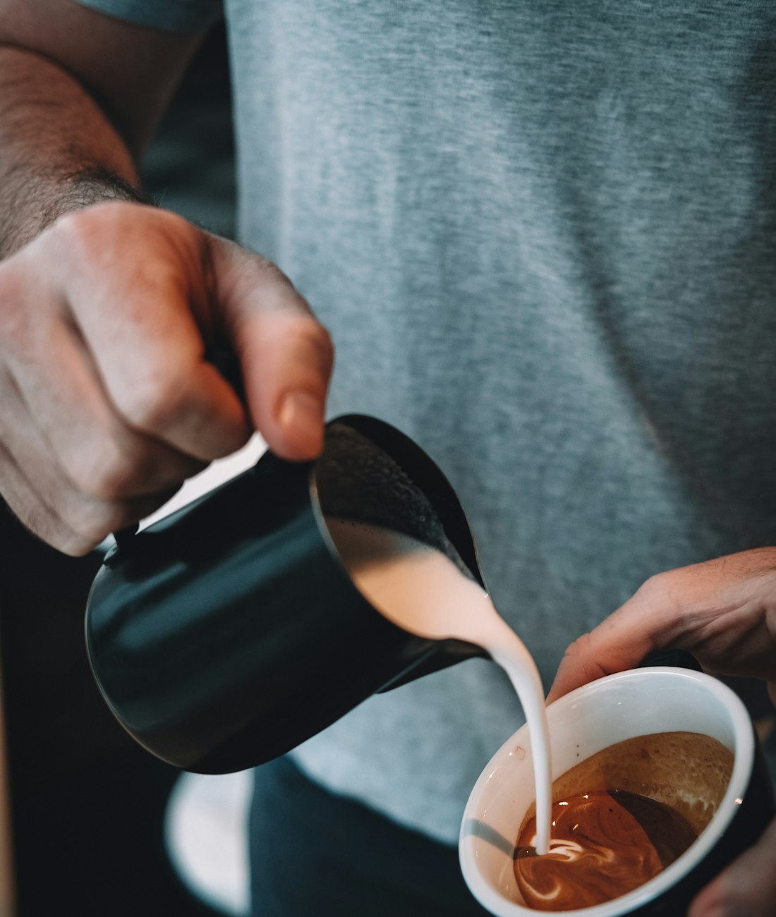 Steamed milk being poured into a flat white