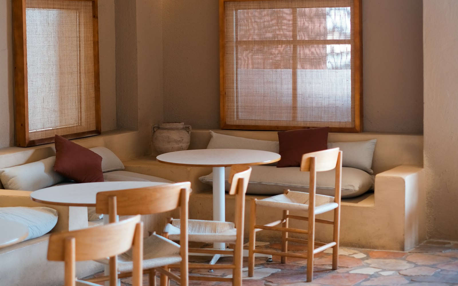 The cafe room in daylight, tables set and waiting